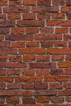 a red brick wall is shown in close up