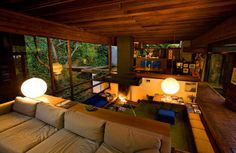 an aerial view of a living room with couches and lamps on the tables in front of it