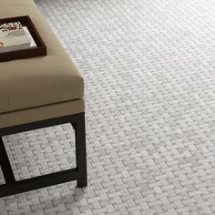 a white tile floor with a bench in the middle