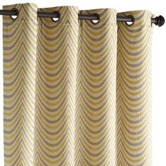 a curtain with an abstract design on the top and bottom, hanging from a metal rod