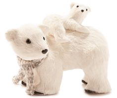 two stuffed polar bears sitting on top of each other in front of a white background