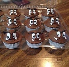 cupcakes with chocolate frosting decorated to look like eyes and mouths on them