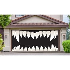 a garage door decorated with an image of a monster's mouth and teeth on it