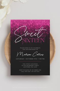 a pink and black sweet sixteen birthday party card on a plate next to white flowers