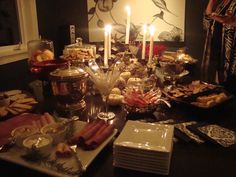 a table filled with food and candles on top of it