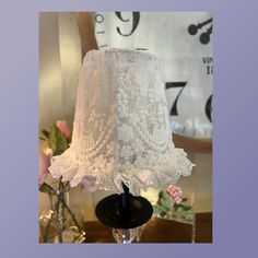 a white lamp shade sitting on top of a table