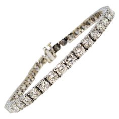 This is an absolutely stunning diamond tennis bracelet that will stand the test of time. The elegant white gold setting paired with the timeless round diamonds makes this piece a true classic that will never go out of style. This gorgeous bracelet features 42 sparkling round diamonds, H-I in color and VS1-VS2 in clarity, and totaling 8.54 carats. The glittering prong set diamonds are set in a single elegant row with the the stones set close for maximum sparkle. The bracelet is made of polished w Bracelet Tennis, White Gold Set, Jewelry Appraisal, Diamond Tennis Bracelet, Tennis Bracelet Diamond, Gorgeous Bracelet, Brilliant Diamond, Tennis Bracelet, Round Brilliant Cut Diamond