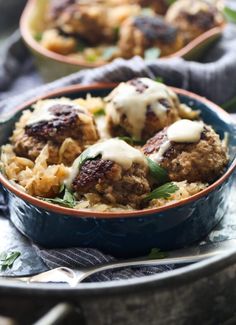 meatballs with gravy in a blue bowl on top of a tablecloth