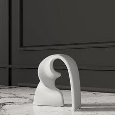 a white sculpture sitting on top of a marble counter