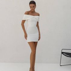 Elevate your evening wardrobe with this stunning white off-shoulder mini dress, crafted from luxurious premium diagonal crepe fabric. The structured corset base ensures a flattering, figure-hugging fit, while the chic bow detail adds a touch of sophistication. Perfect for cocktail parties, date nights, or special occasions, this dress will make you stand out in effortless elegance.  Off-shoulder design with a stylish bow detail Corset base for a sleek, form-fitting silhouette Premium diagonal crepe fabric for a luxurious feel Perfect for cocktail events, parties, and evening wear Available in sizes XS, S, M, and L White Short Wedding Dress, Wedding Dress Mini, Short White Dress Wedding, Structured Corset, White Off Shoulder, Mini Cocktail Dress, Short Wedding Dress, Dress Mini, White Short