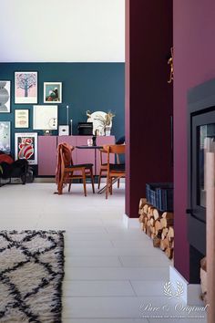 a living room filled with furniture next to a fire place and wall covered in pictures