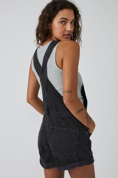 A summertime staple... The shorts version of Free People's fan favorite Ziggy Overalls, the Ziggy Shortalls are a must-have for your carefree summer adventures. Features: Women's black denim shorts overalls Relaxed fit Bib-and-brace Front bib pocket Rolled hemlines Adjustable straps Side button closures Five pocket design Frayed cuffs Measurements: Hips: 43" Rise: 11.75" Waist: 34" Inseam: 5.5" Based on size small Materials/Care: 100% Cotton Machine washable Ziggy Shortalls, Ziggy Overalls, Black Dungaree, Denim Romper Shorts, Ragged Jeans, Grunge Jeans, Dungarees Shorts, Denim Overalls Shorts, Short Overalls