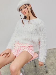 a woman sitting on a chair wearing a hat Oversized Fringe Sweater For Winter, Knit Fringe Top For Fall, Knit Top With Fringe For Fall, Fall Knit Tops With Fringe, White Textured Knit Top, Spring Fringe Long Sleeve Sweater, Spring Long Sleeve Sweater With Fringe, Spring Long Sleeve Fringe Sweater, White Textured Knit Acrylic Tops