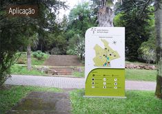 there is a sign in front of some trees and stairs that are on the grass