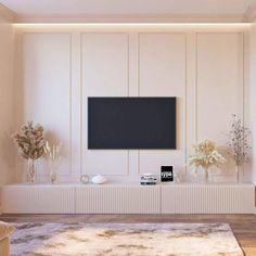 a living room with white walls and a flat screen tv mounted on the wall above it