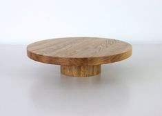 a round wooden object sitting on top of a white table