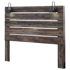 the headboard is made out of wood and has two metal hooks on each side