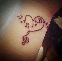 a heart with musical notes on the wrist