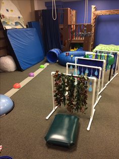 an indoor play area with climbing plants and slides