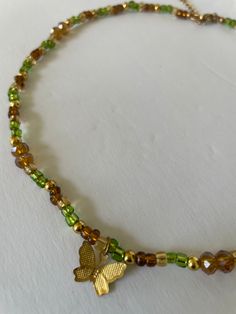 Look beautiful while embracing the spirit of nature with our Forest Fairy Necklaces. A unique blend of hand beaded glass in green, brown and gold, these necklaces are made of glass beads and 14K gold plated beads for lasting wear. Stand tall with nature. Green Beaded Necklace With Gold Beads As Gift, Green Necklaces With Gold Beads For Jewelry Making, Green Necklaces With Gold Beads For Gift, Green Necklace With Gold Beads As Gift, Green Necklace With Gold Beads For Gift, Nature-inspired Gold Jewelry With Round Beads, Handmade Nature-inspired Gold Necklace, Handmade Gold Nature-inspired Necklace, Nature-inspired Gold Beaded Jewelry