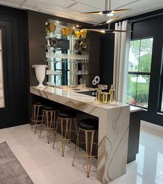 an elegant bar with stools in the middle