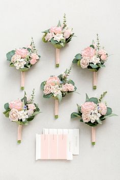 the bridal bouquets are arranged on top of each other, with pink and white flowers