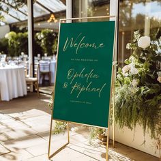 a welcome sign sitting on top of a wooden easel in front of a table