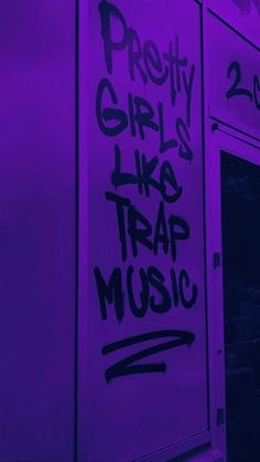 graffiti written on the side of a building with purple light behind it and words that read pretty girls like trap music