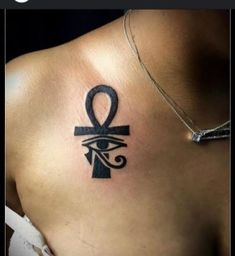 an egyptian symbol on the back of a woman's shoulder