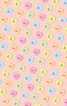 colorful candy hearts on a pink background with the words love you so much written in different languages