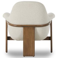 an upholstered chair with wooden legs and white fabric on the armrests