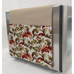 a close up of a microwave door with a floral design on it's side