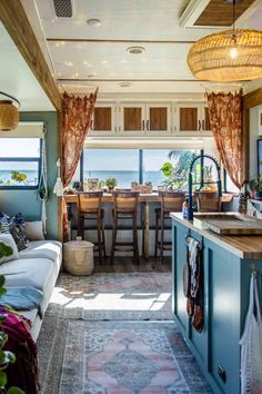 a living room and dining area with an ocean view from the kitchen in a mobile home