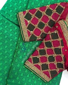 the green and red saree is laying on top of the other pieces of clothing