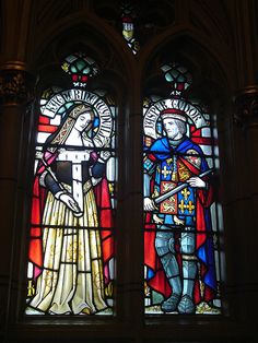 two stained glass windows depicting knights in armor and holding swords, with one standing behind the other