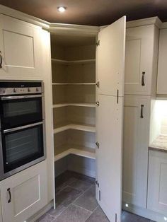 a kitchen with white cabinets and an oven