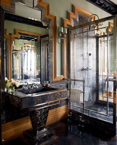 a bathroom with a sink, mirror and shower in it's own area that is well decorated