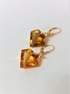 "Beautiful Shield Cut Orange Citrine Gemstones and 14K Gold Filled Drop and Dangle Earrings. These outstanding Dangles have Shield Cut Orange Citrine Gemstones. Beautifully colored Orange Citrine Gemstones that measure 19.1 mm long x 20.8 mm wide x 10.7 mm deep. These stones are 39.60 carats in weight and are stones are IF (internally Flawless). They are large impressive Citrine Stones.These Gemstones have the most beautiful Fire and Sparkle. These earrings come with soft silicone earring backs. Elegant Orange Earrings For Anniversary, Gold Topaz Earrings For Anniversary, Orange And Gold Jewelry, Topaz Drop Earrings For Gift, Orange Teardrop Jewelry For Formal Occasions, Orange Pierced Earrings For Formal Occasions, Elegant Formal Citrine Earrings, Gold Crystal Gemstone Earrings For Anniversary, Formal Drop Citrine Jewelry