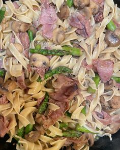 Sautéed mushrooms in butter and oil then add fresh garlic. when mushrooms are almost cooked, Add asparagus. When done, add the cut up prosciutto and toss with noodles.