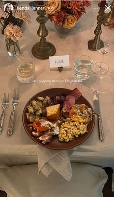 a plate with food on it sitting on top of a table next to silverware