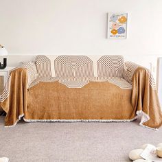 a living room with a couch covered in a blanket