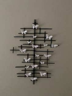 a wall sculpture with many butterflies on it