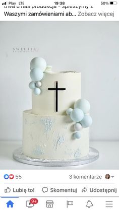 a white cake with blue frosting and a cross on top