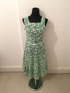 Pretty summer dress in a lightweight green and weight cotton Square neckline, fitted bodice with a zip to side of bodice Large frill hem Calf length/ maxi dress  Most likely handmade  Best fit size UK 10 or 10-12 or size medium  Bust 33 inches/ 84cm Hips free Length (top of back to hem)  105cm Fitted Green Midi Sundress, Fitted Green Sundress Midi Dress, Fitted Green Maxi Sundress, Green Fitted Sleeveless Midi Dress, Green Sleeveless Midi Dress With Fitted Bodice, Green Cotton Dress With Ruffle Hem, Fitted Green Cotton Sundress, Green Ruffled Sundress Midi Dress, Green Dresses With Floral Print And Fitted Bodice