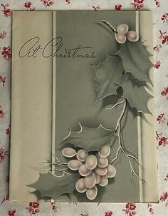 an old christmas card with holly leaves and berries