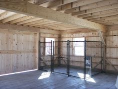 an empty room with wood paneling and metal caged in doors on the walls