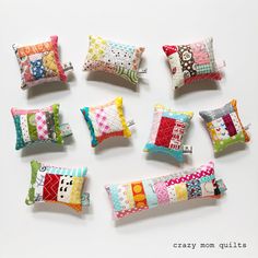 nine pillows are arranged in a circle on a white surface with the words crazy mom quilts written below them