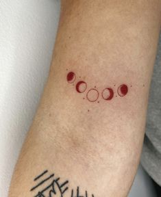 a person with a tattoo on their arm that has three circles and the word love written in it