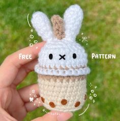 a small crocheted cupcake with a bunny face on it's side