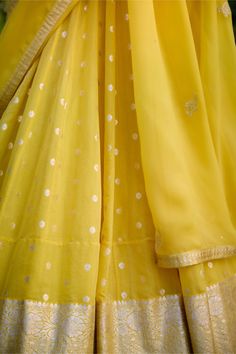 Illuminate the occasion in this daffodil yellow chanderi jacquard lehenga, adorned with enchanting lurex patchwork and intricate thread embroidery. Paired gracefully with an organza dupatta, this ensemble exudes elegance and charm. Crafted with meticulous attention to detail, it's the perfect choice for those seeking to make a radiant statement at any special occasion. Yellow Silk Palazzo Set For Wedding, Festive Yellow Chikankari Palazzo Set, Yellow Chikankari Embroidery Raw Silk Salwar Kameez, Yellow Raw Silk Salwar Kameez With Chikankari Embroidery, Festive Yellow Palazzo Set With Chikankari Embroidery, Bollywood Style Yellow Raw Silk Palazzo Set, Yellow Silk Salwar Kameez With Chikankari Embroidery, Yellow Silk Sets With Gota Work, Yellow Anarkali Chanderi Palazzo Set